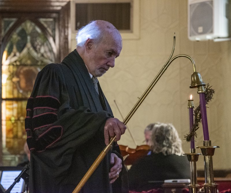 Candles support a crown of thorns as the Rev. Dr. S. Willard Crossan III snuffs them at the end of the performance.